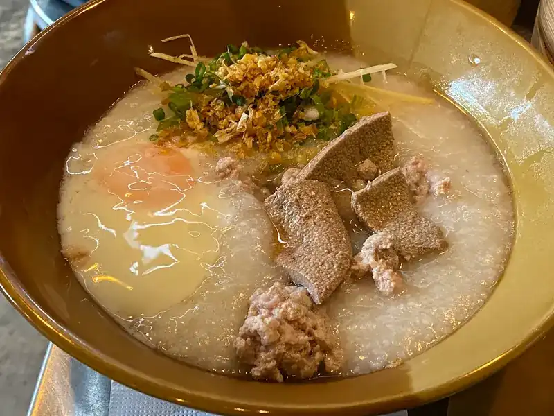Rice congee with minced pork, liver, a soft egg and fried garlic