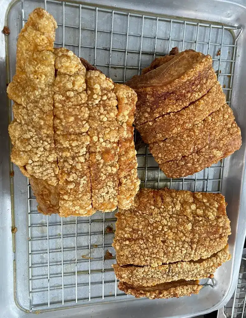 Slabs of crispy pork belly on a wire rack