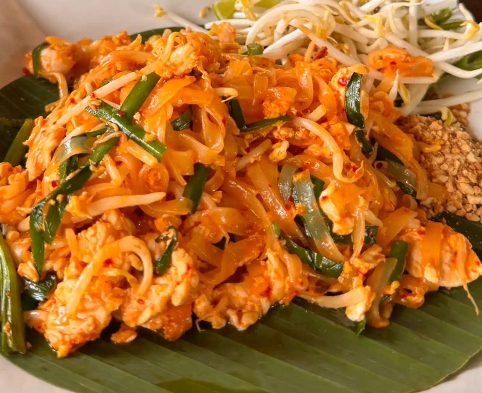 Pad thai on a banana leaf with bean sprouts and crushed peanuts | ผัดไทยบนใบตอง พร้อมถั่วงอกและถั่วลิสงป่น