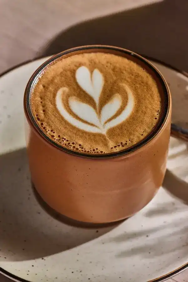 Latte art in a clay-coloured cup