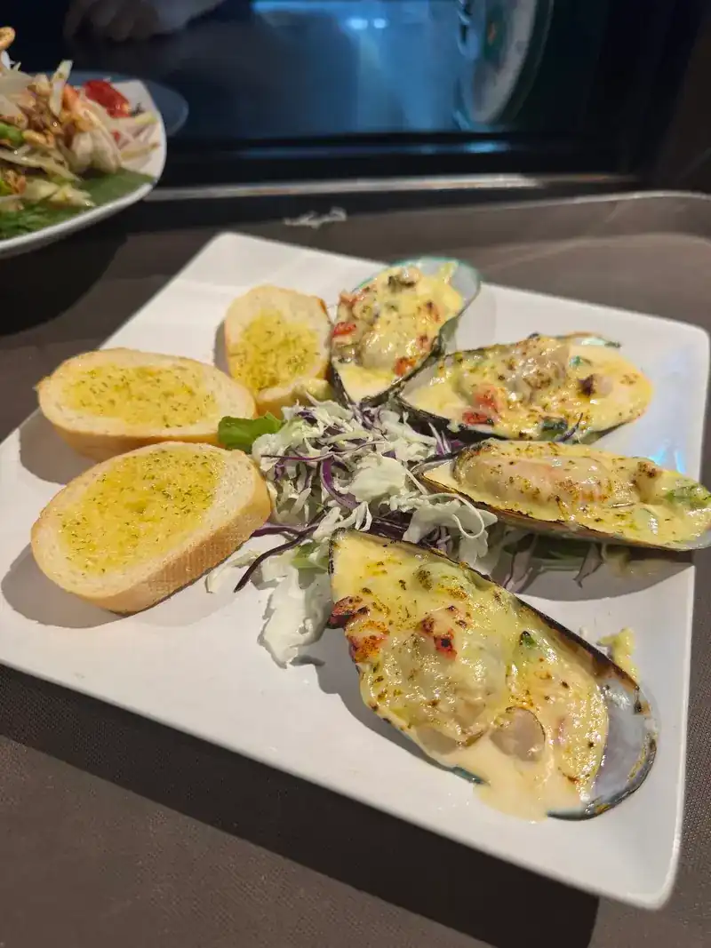 Baked mussels on the half shell with garlic bread