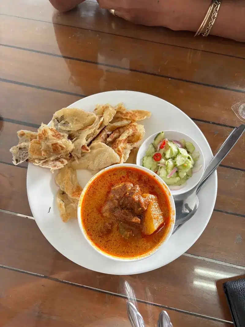 Massaman curry with flaky roti and cucumber relish