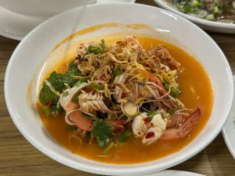Prawns and squid in a spicy orange broth with herbs