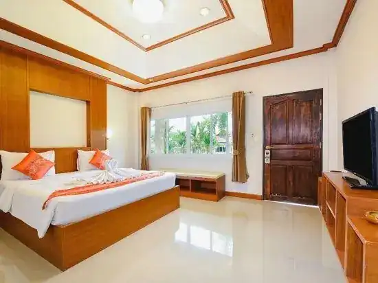 A bright double room with a wooden door and TV