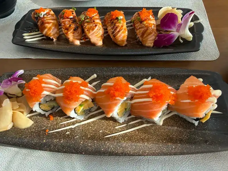 Seared salmon nigiri and salmon rolls with orange roe and mayonnaise