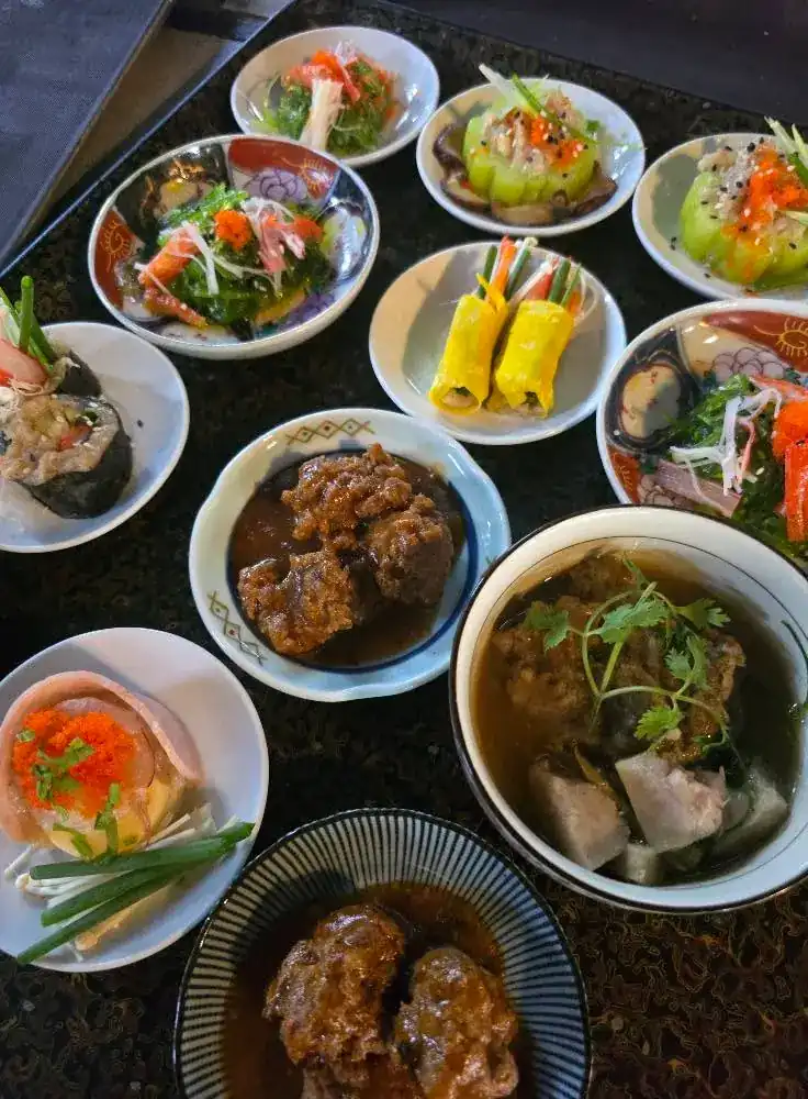 Bowls of dim sum and braised dishes seen from above