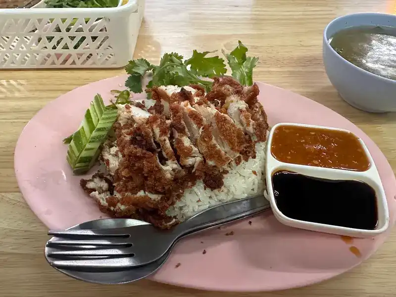 Fried chicken on chicken rice with two dipping sauces
