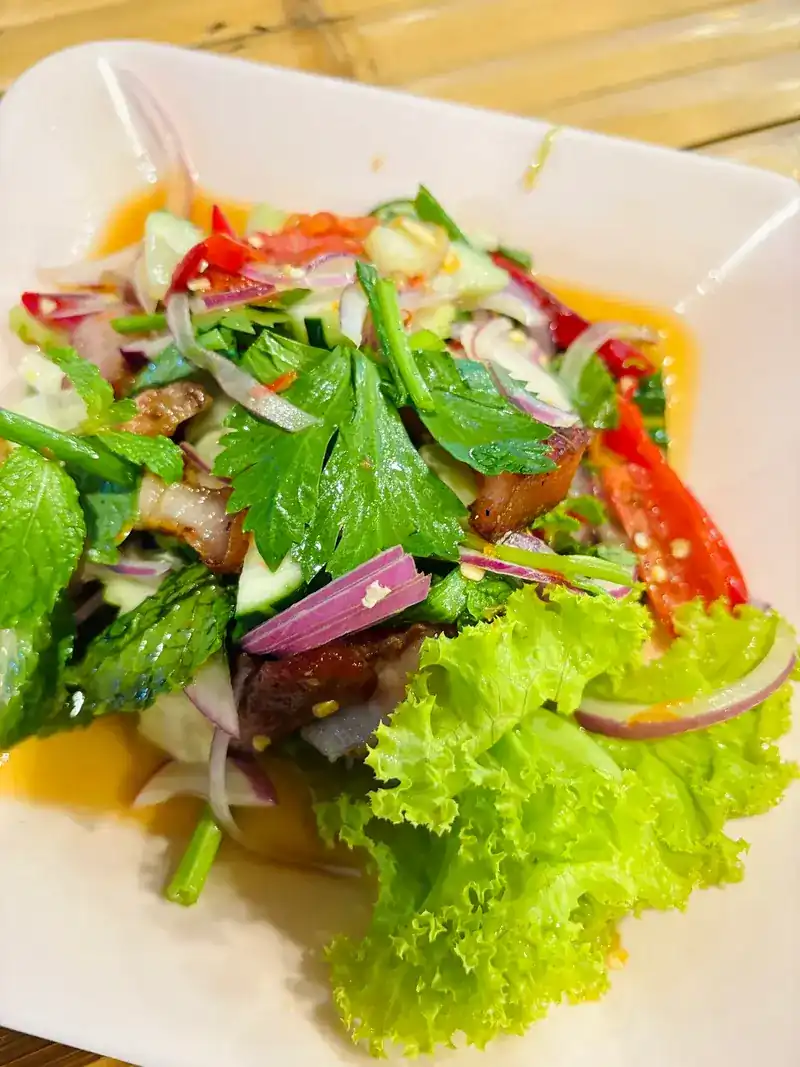 A spicy yum salad with herbs, shallots, chilli and lettuce