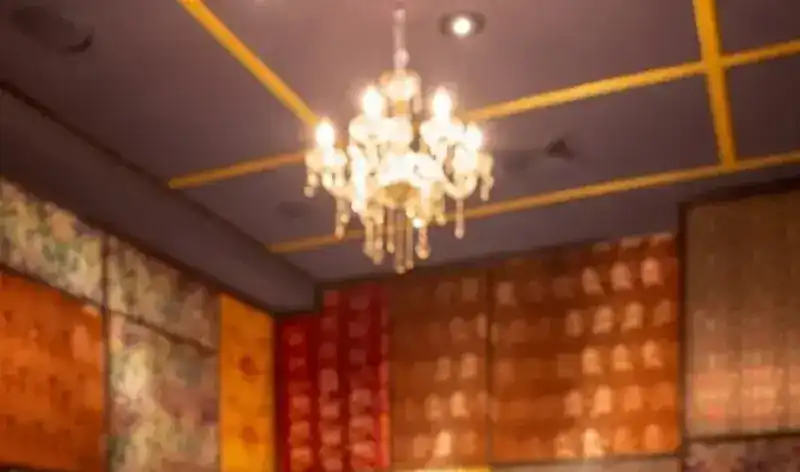 The Silk Room: walls of patchwork silk brocade under a crystal chandelier
