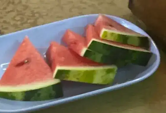 Slices of watermelon on a plate at a guest's table