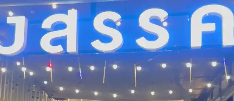 Their sign at night: big white Thai letters on a blue fascia, above the string lights