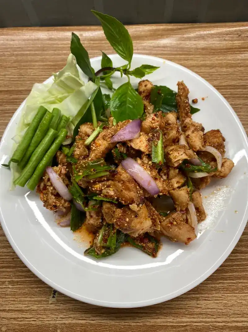A spicy dish tossed with toasted rice, basil, shallot and long beans