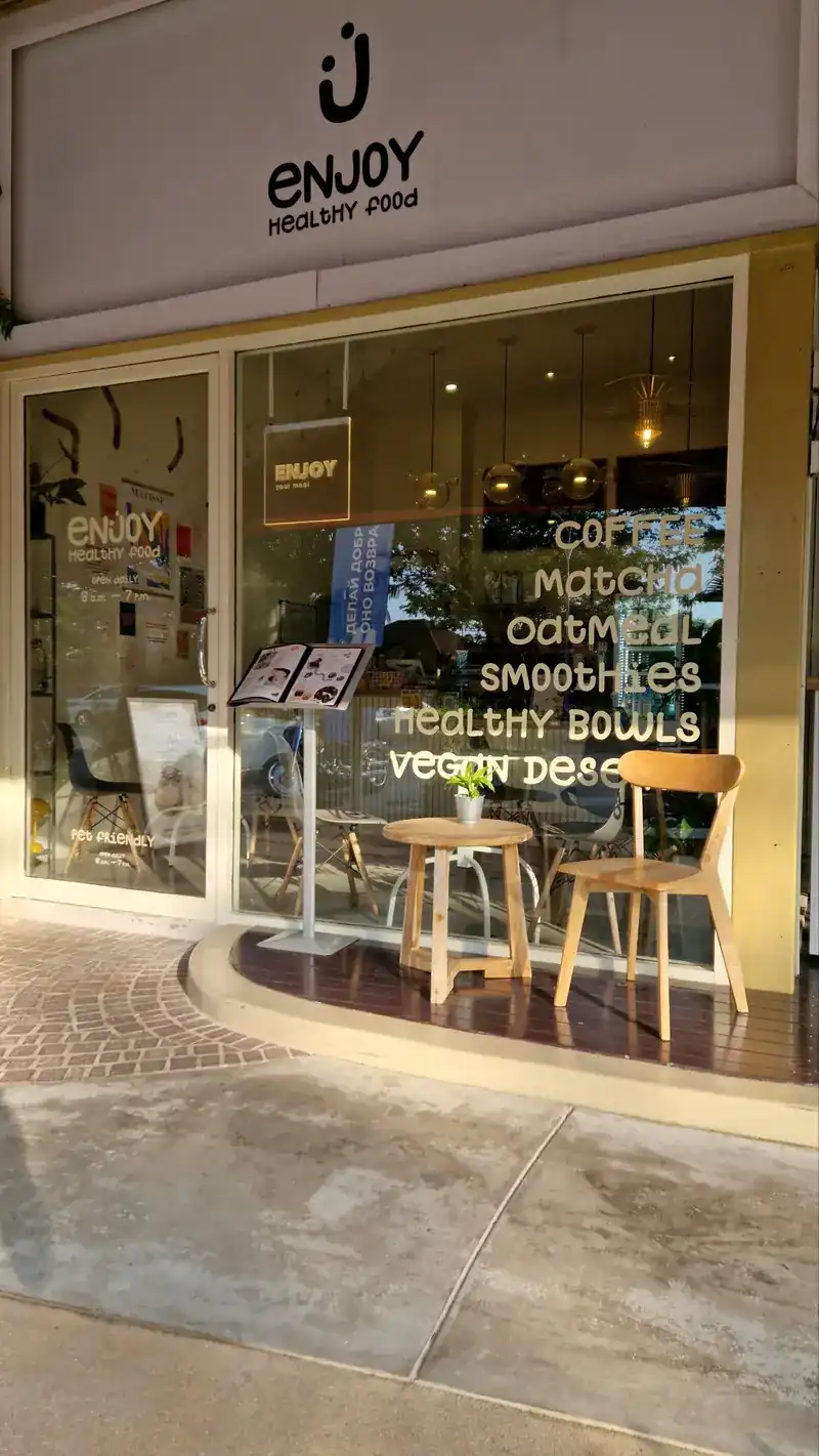 The shop front at Blue Tree, its window lettered with coffee, matcha, oatmeal, smoothies, healthy bowls and vegan desserts
