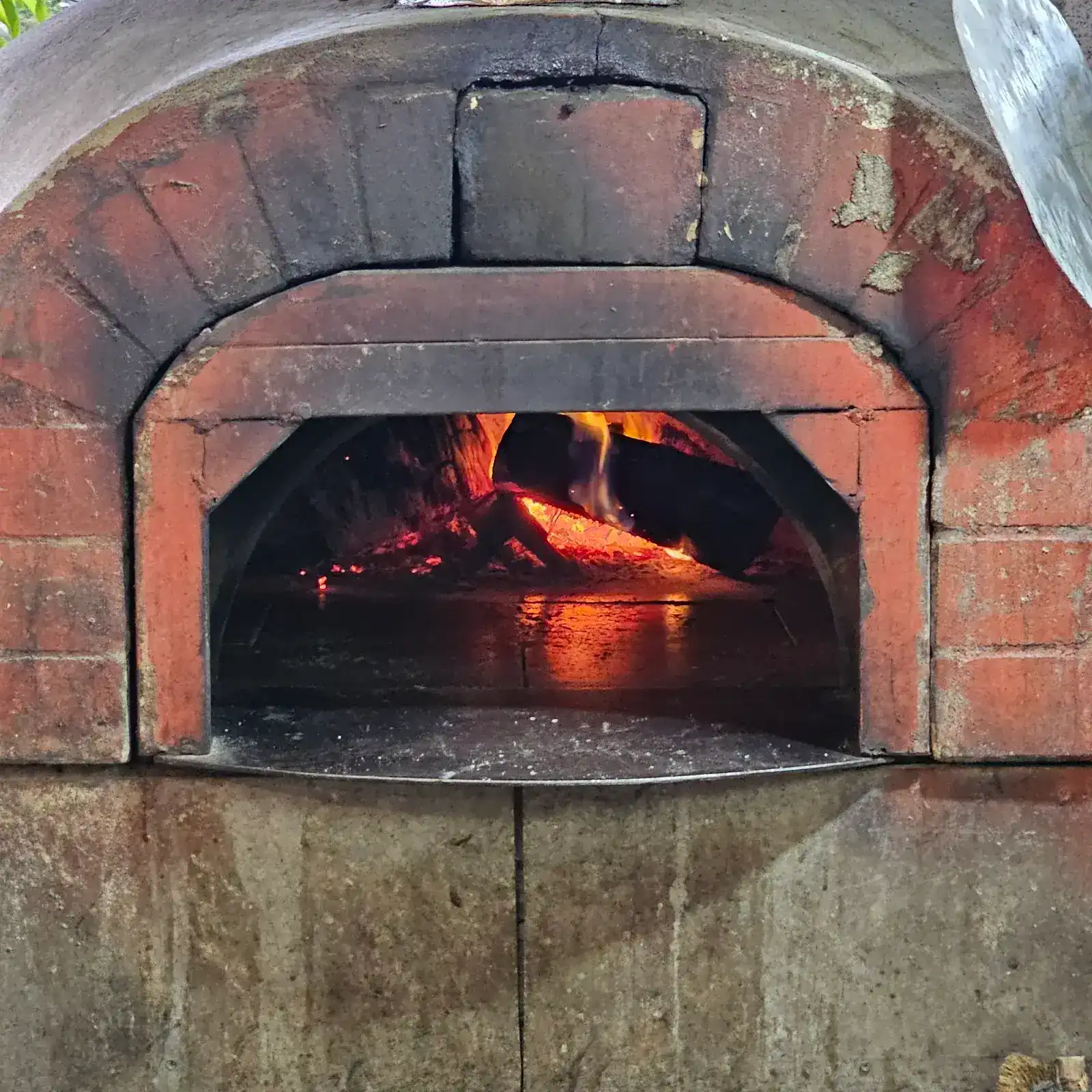 Wood burning inside Bravo's brick pizza oven