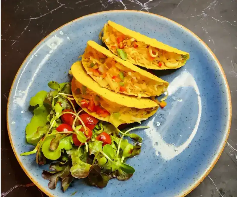 Tacos with salad on a blue plate