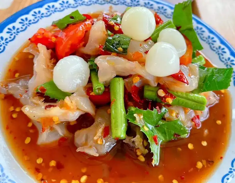 A spicy seafood salad with long beans and herbs in a chilli dressing
