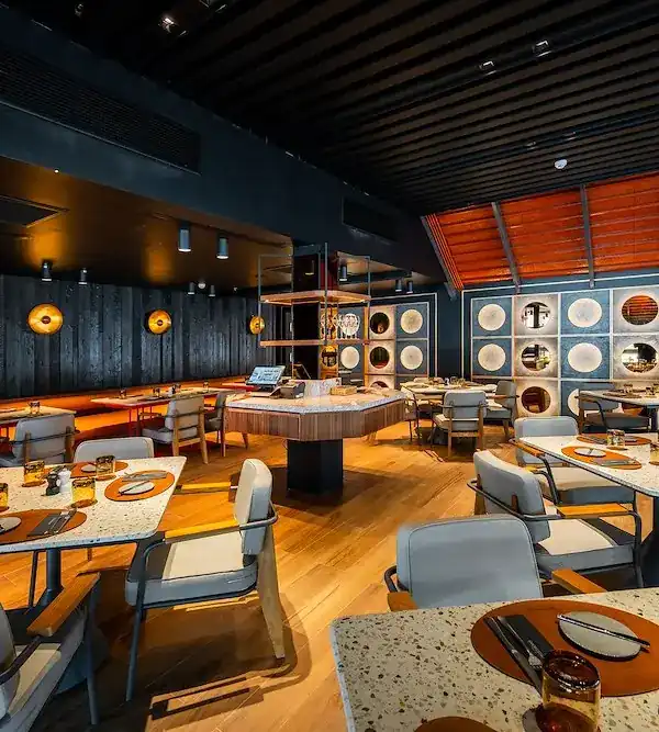 The upstairs dining room with terrazzo tables and charred wood walls