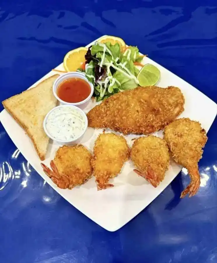 Breaded fish steak and shrimps with salad, toast and two dips