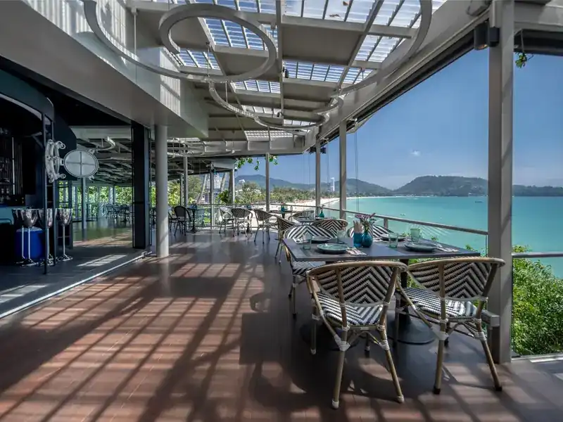 The long terrace in afternoon light, with the bay beyond