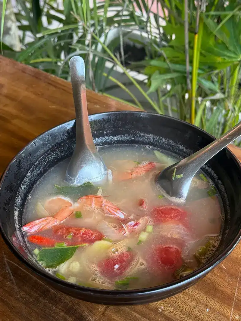 A clear prawn soup with tomato and chilli