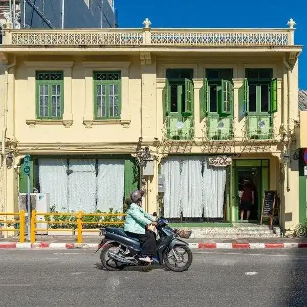 One Chun's two-storey yellow Sino-Colonial house with green shutters, seen from the street