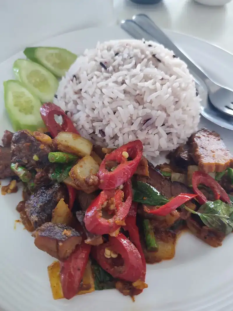 A stir-fry with red chillies, served with rice and cucumber