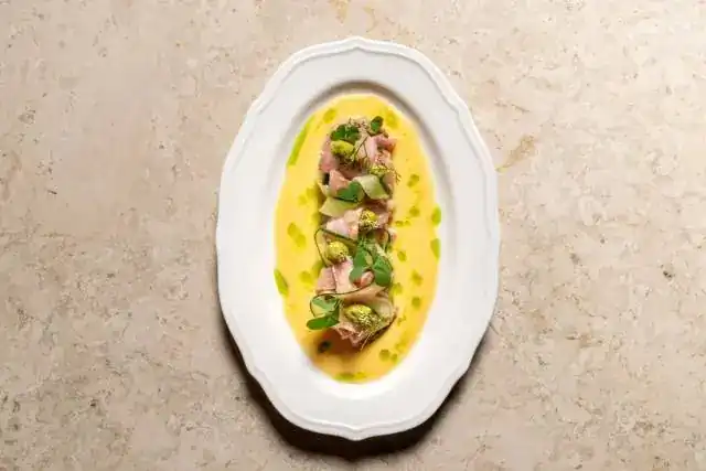 Bluefin tuna tartare with yuzu and avocado on a white oval plate