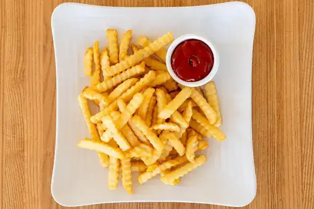 Crinkle-cut French fries with ketchup