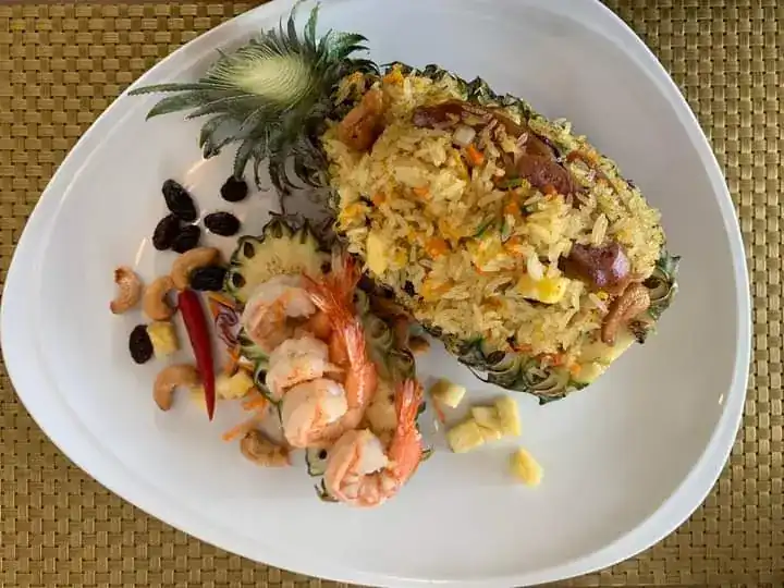Khao ob sabparot: pineapple fried rice with prawns, served in half a pineapple with cashews and raisins