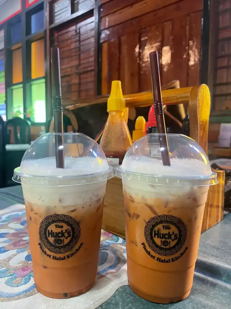 Two iced teas with milk in The Huck's own cups