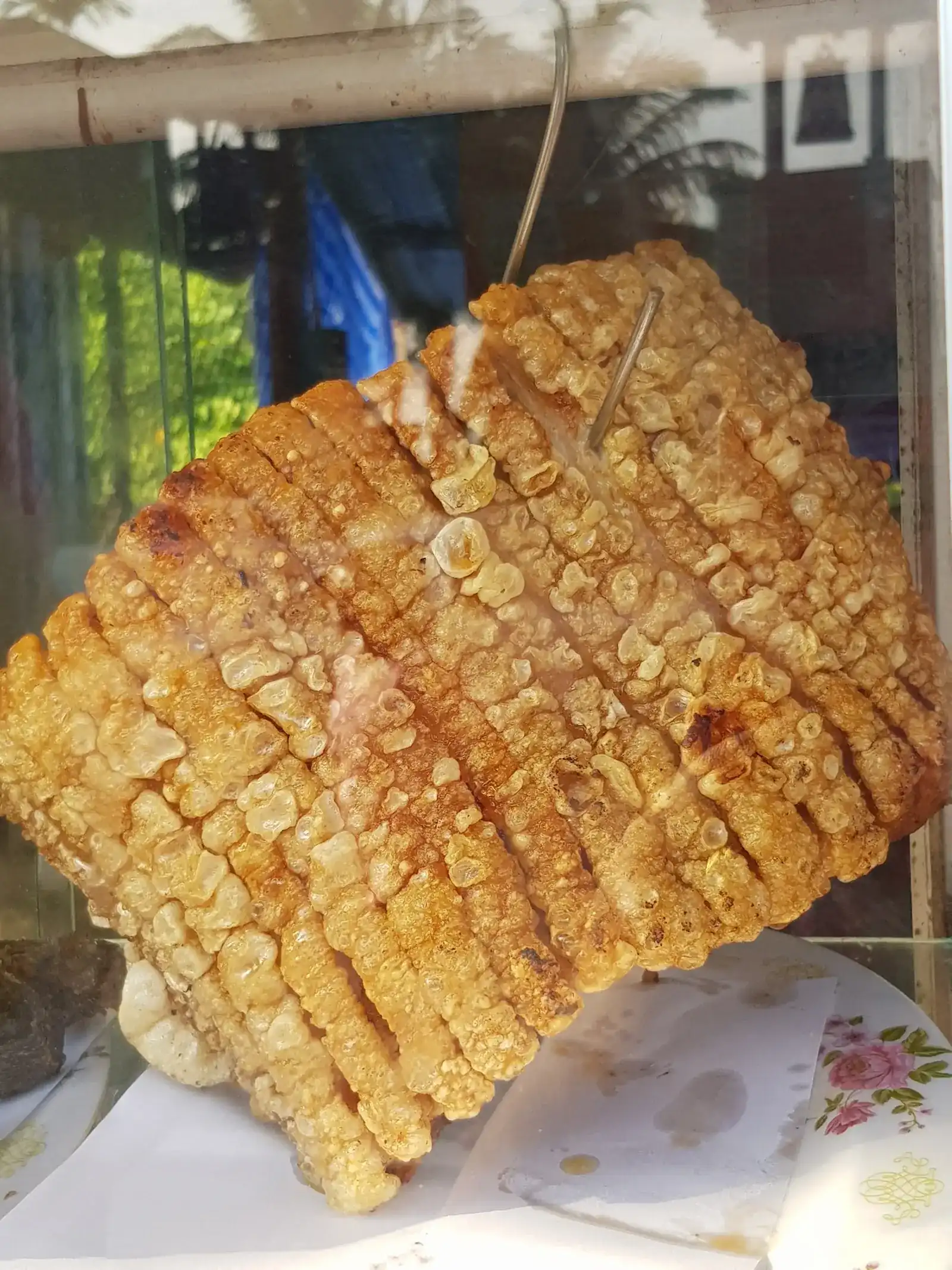 Crispy pork belly hanging in the shop's glass cabinet