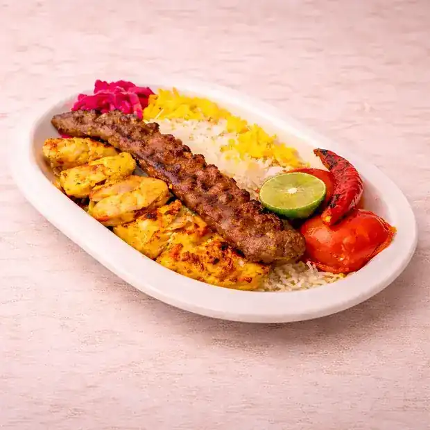 The Minister Meal: kebab skewers on rice with grilled tomatoes