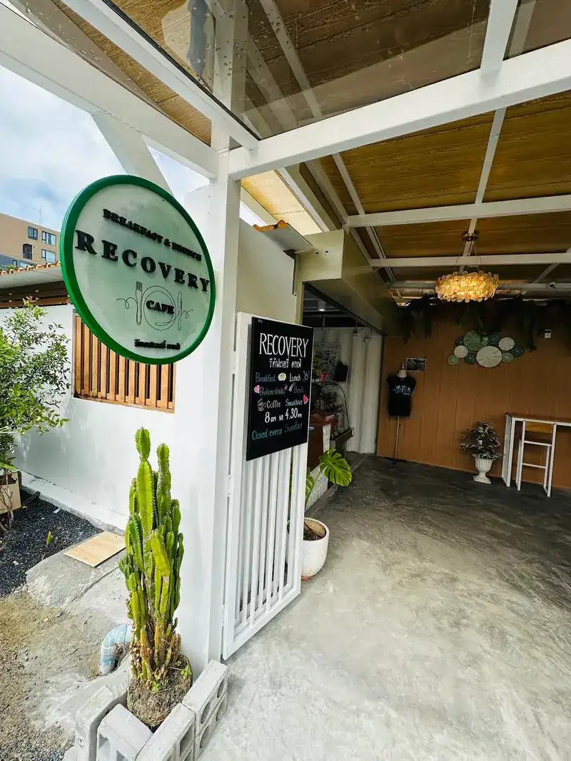 The entrance with the round green Recovery sign and the chalkboard