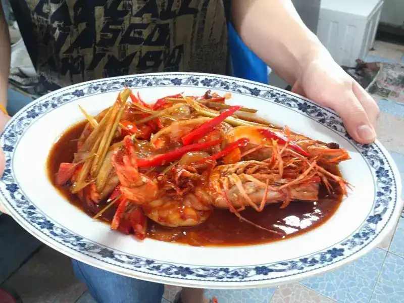 Large prawns in a glossy red sauce with lemongrass and chilli