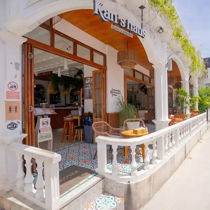 The road-side front of Kan's haus: white balustrades, wooden doors and patterned floor tiles