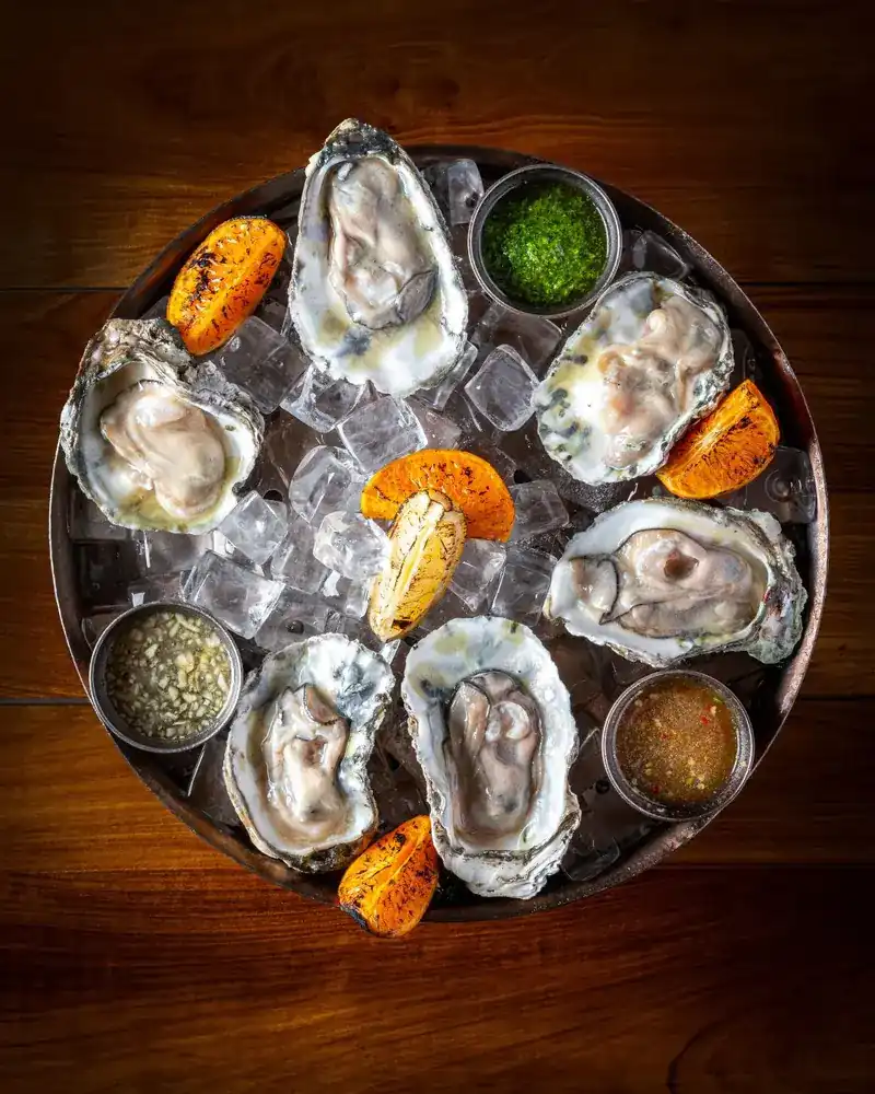 Oysters on ice with charred citrus and three sauces