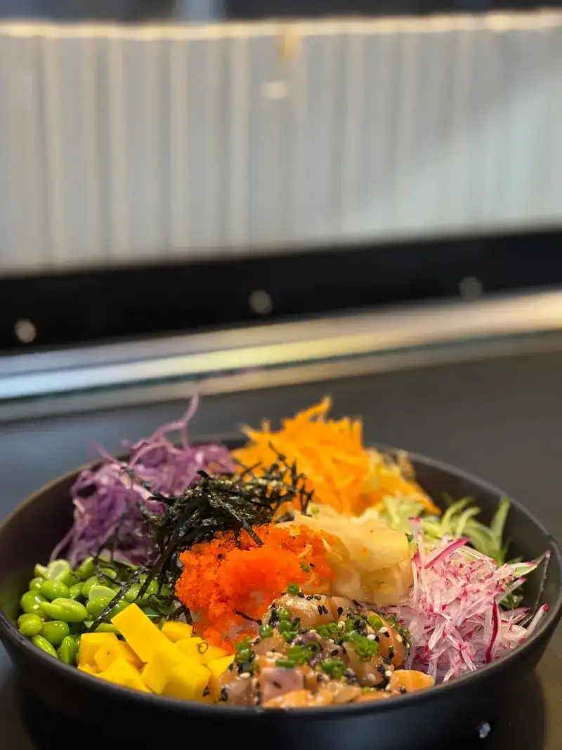Poke bowl with salmon, edamame, shredded vegetables and fish roe