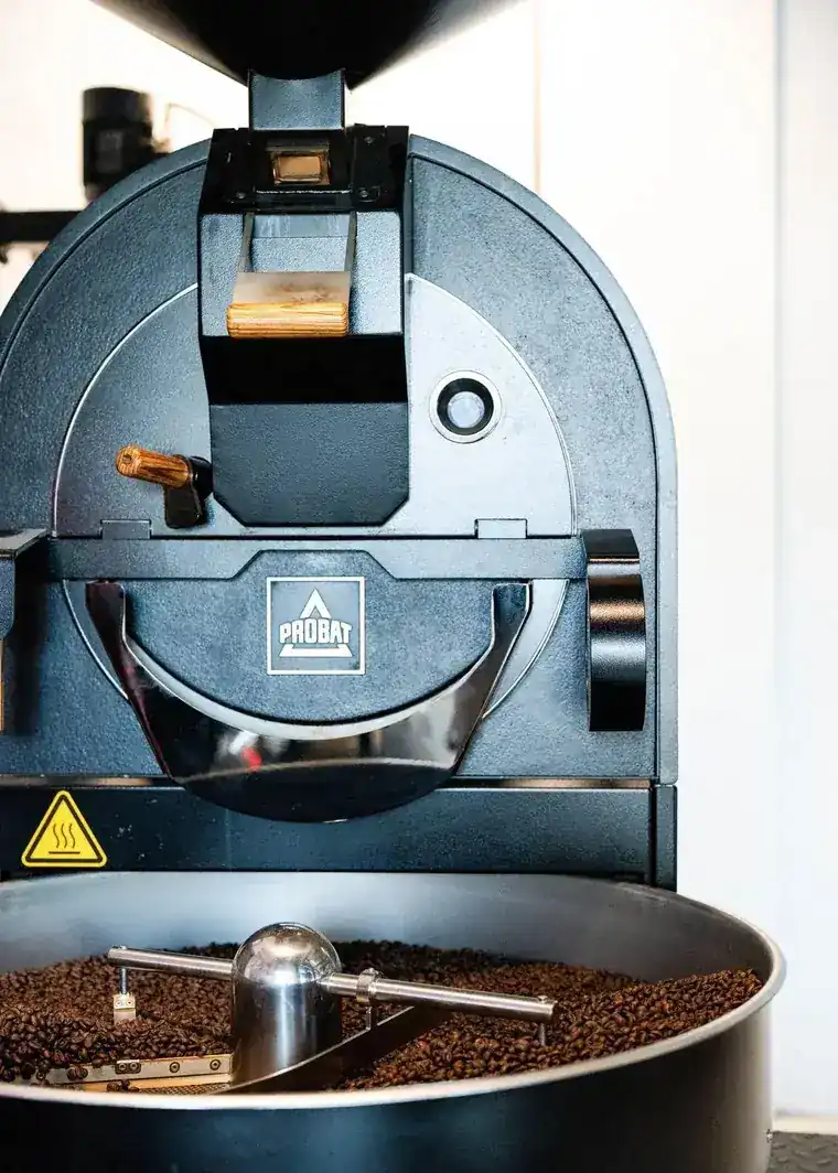 The Probat roaster turning freshly roasted beans in its cooling tray