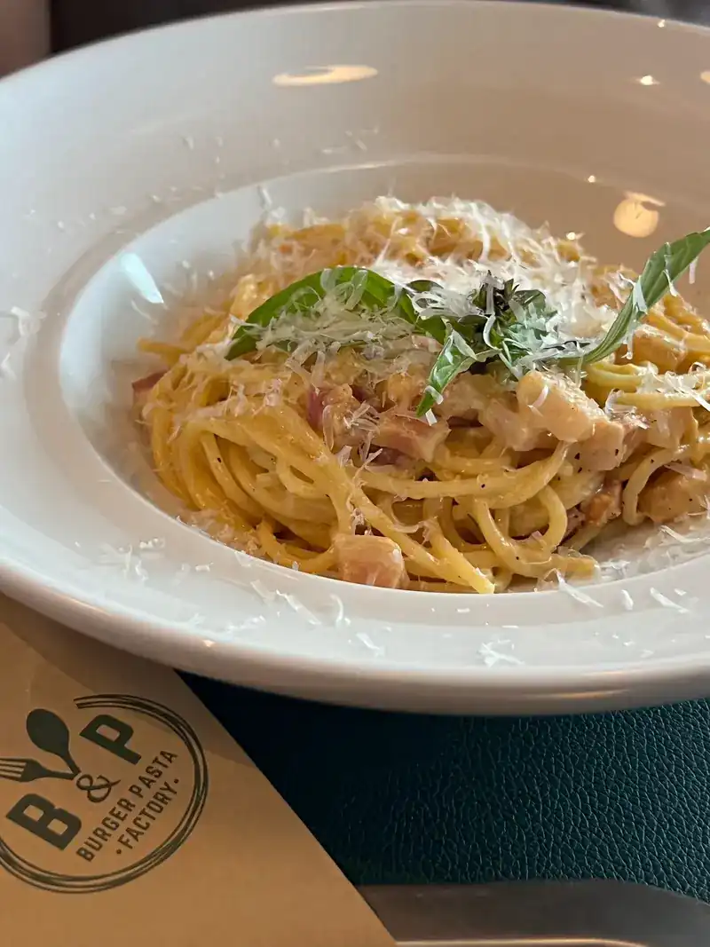 Spaghetti in a creamy sauce with parmesan and basil