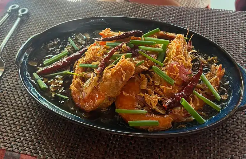 Large prawns under crisp shallots, dried chillies and spring onion in a dark glossy sauce