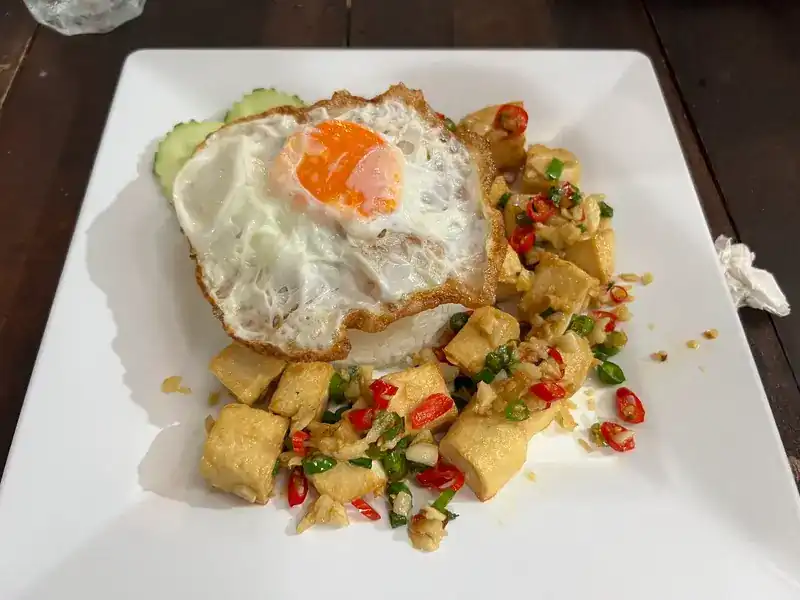 Fried tofu with chilli, garlic and spring onion, with a fried egg