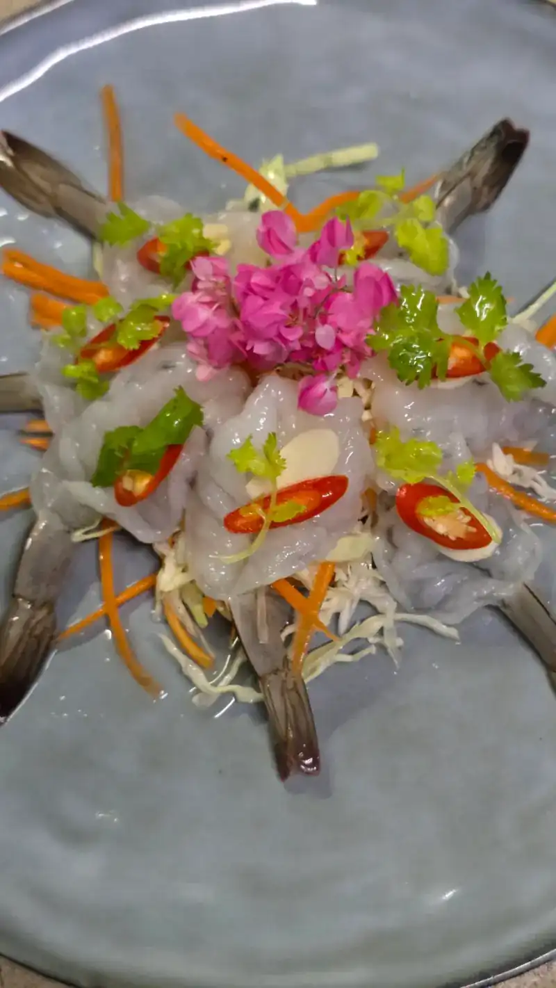 Prawns dressed with chilli, garlic and coriander, topped with pink flowers