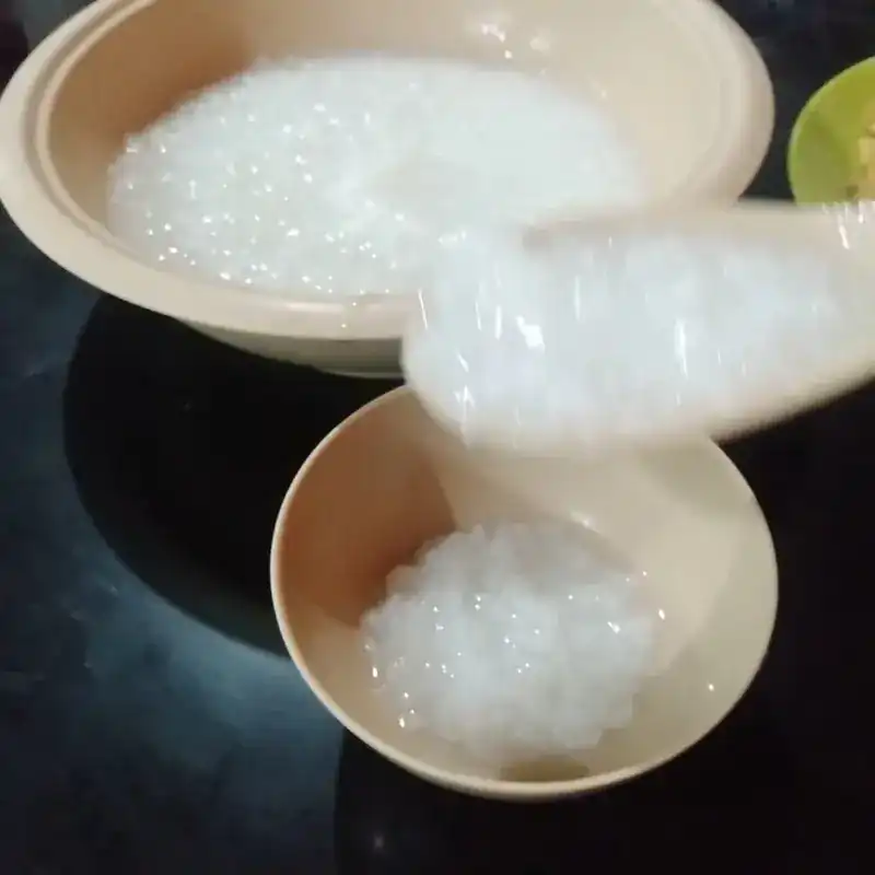 Plain rice porridge ladled into a small bowl