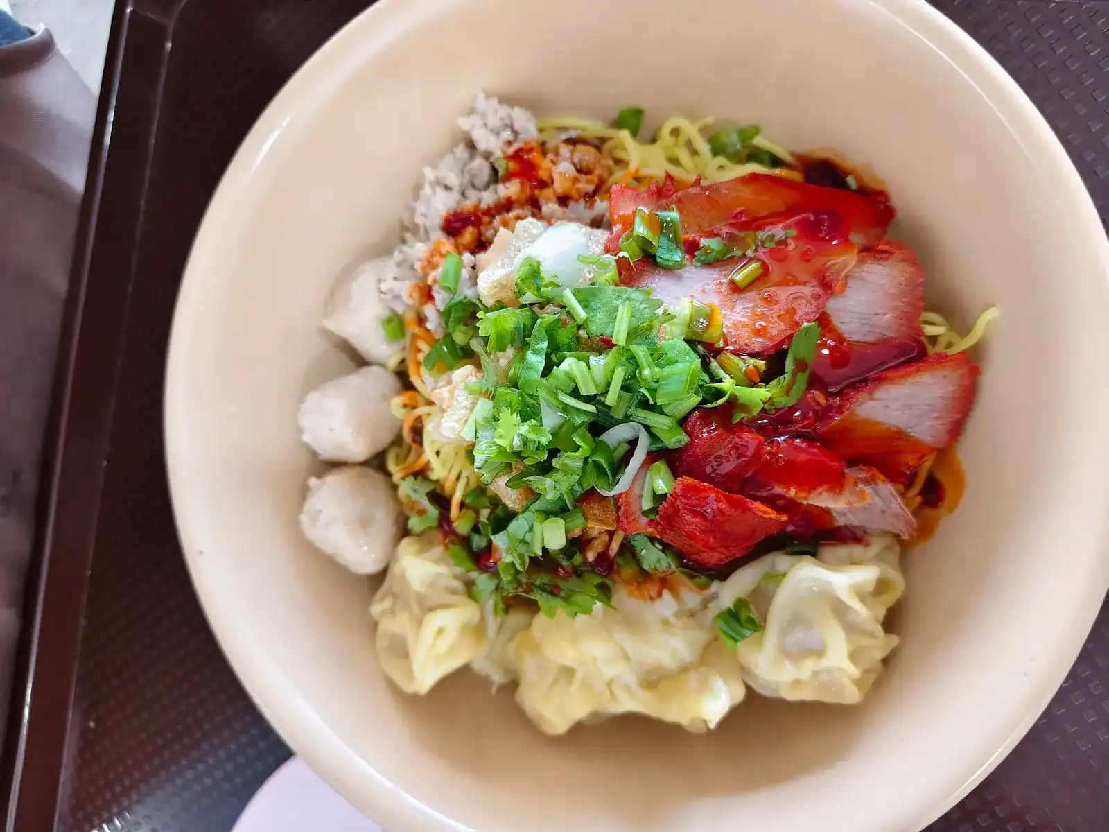 Dry egg noodles with red pork, wontons and meatballs