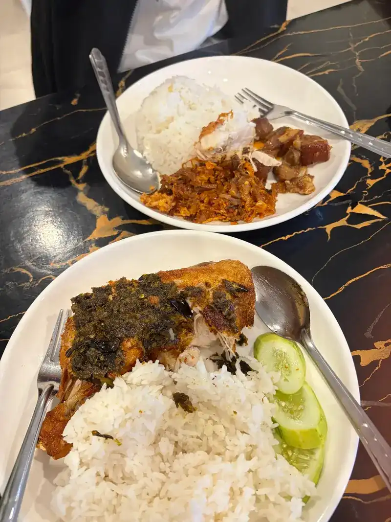 Two rice plates on a black-and-gold table