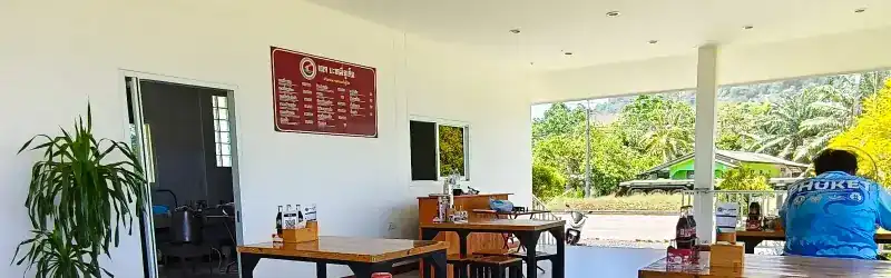 The open hall and terrace, looking out to palm trees and hills