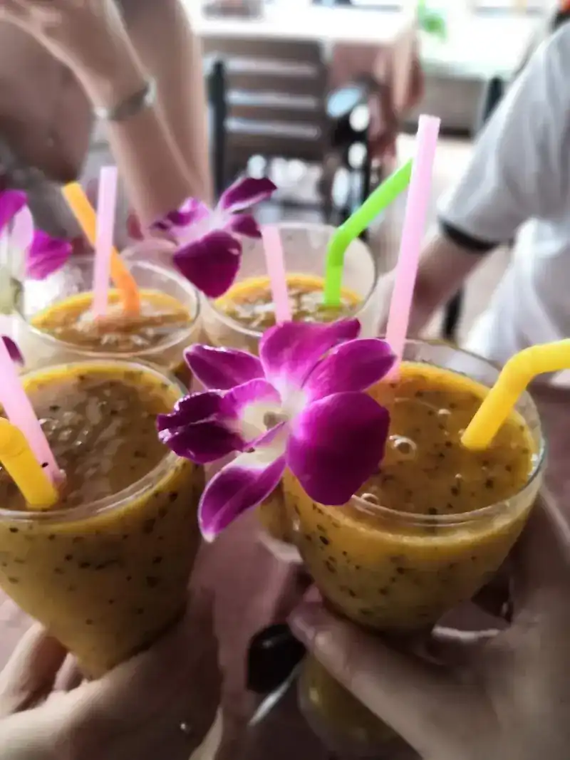 Four passion fruit drinks with orchids and bright straws