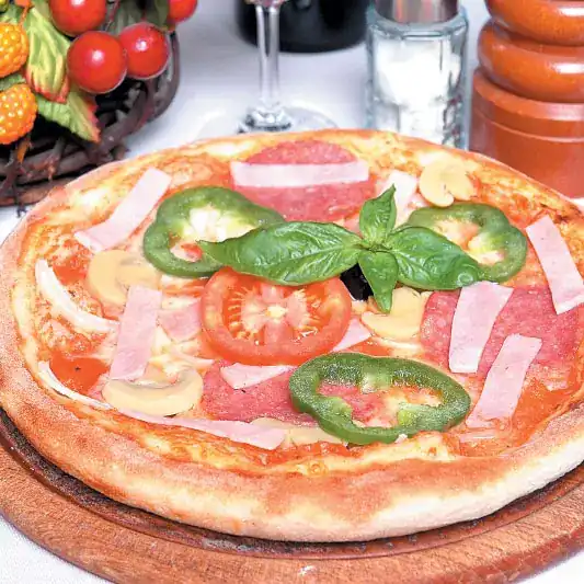 Pizza with salami, ham, mushrooms and green pepper