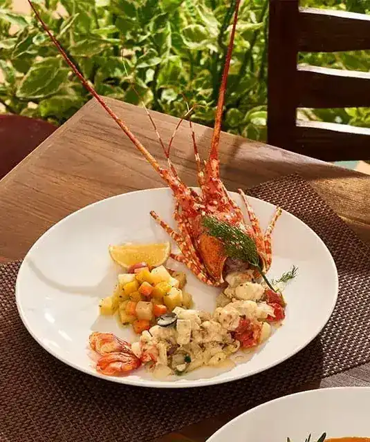 A Phuket lobster plated with diced vegetables and seafood