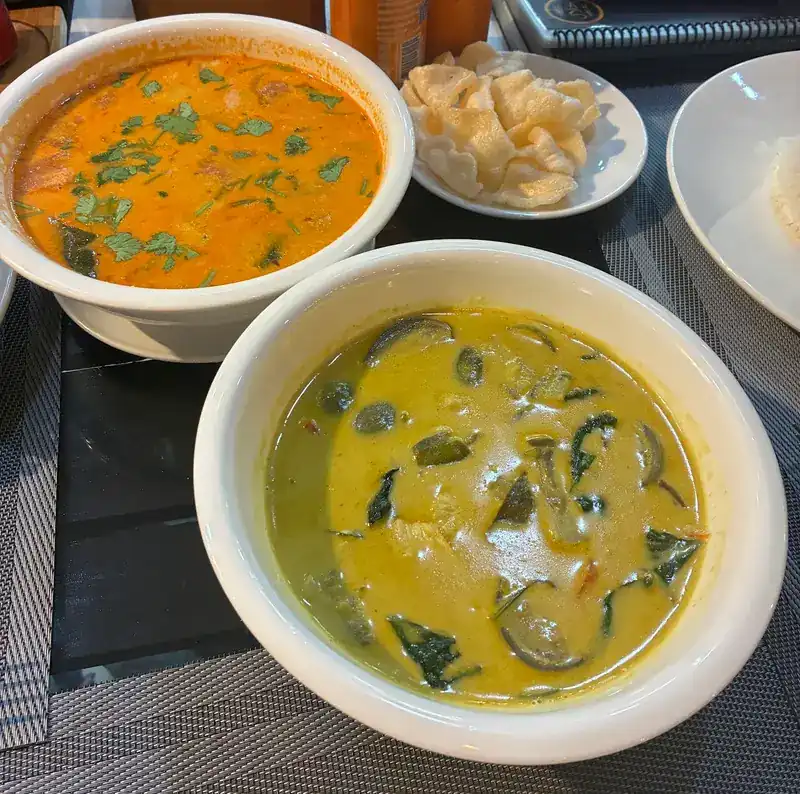 Green curry with Thai eggplant and basil, beside a second curry / แกงเขียวหวานใส่มะเขือและใบโหระพา คู่กับแกงอีกถ้วย